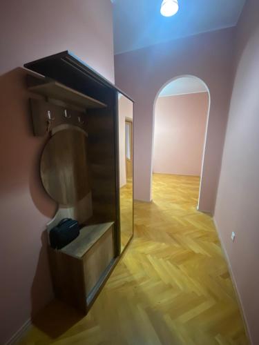 a mirror in a room with a wooden floor at Apartment in Poti in Poti
