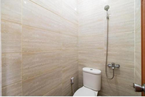 a bathroom with a toilet and a shower at Nyenyak Senayan Benhil in Jakarta