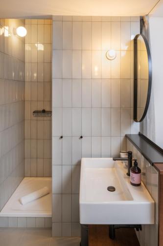 a bathroom with a sink and a shower at magdas HOTEL Vienna City - First Social Business HOTEL in Austria in Vienna
