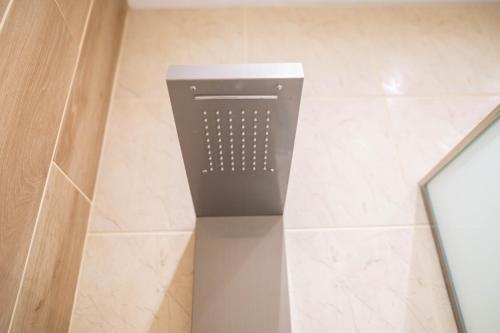 a trash can sitting in the corner of a bathroom at Kosnian City Suites in Kos