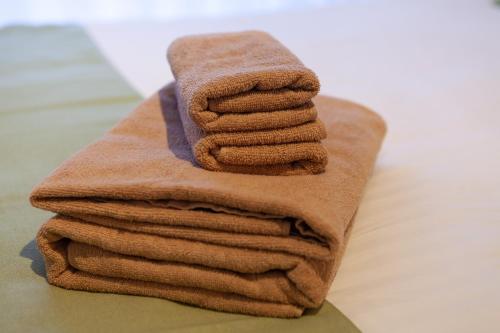 a stack of towels sitting on top of a table at REJ Reflet Ebisu in Tokyo