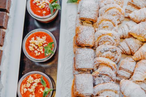 two pictures of a buffet of food with salsa at Hotel Adler - Czech Leading Hotels in Prague
