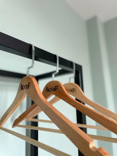 a pair of wooden spoons hanging from a rack at Leaf Hotel Phu Quoc in Phu Quoc