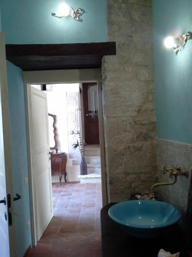 a bathroom with a sink and a stone wall at Antica Taverna del Principe in Sepino