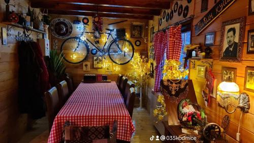 a dining room with a table and bikes hanging on the wall at Odmaraliste Kod Miće Apartman 3 in Krušar