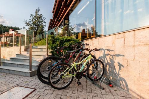 two bikes are parked next to a building at Ruskovets Thermal SPA & Ski Resort in Bansko