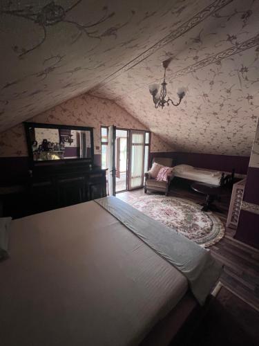 a bedroom with a large bed in a attic at Casa Izac in Botoşani