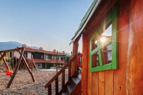 a building with a playground with a window and a swing at Ruskovets Thermal SPA & Ski Resort in Bansko