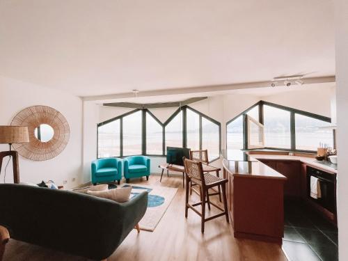 a living room with a couch and a table and chairs at Just Like Home - Blue River in Caminha