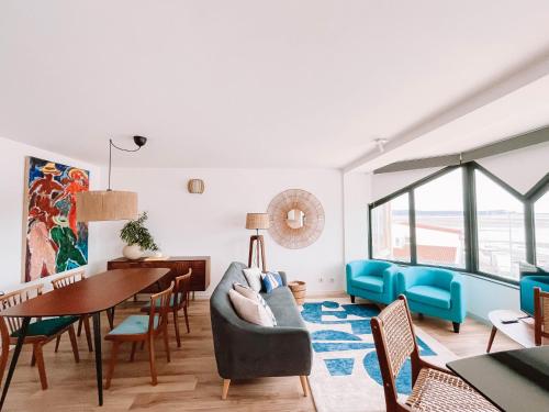 a living room with a couch and a table at Just Like Home - Blue River in Caminha