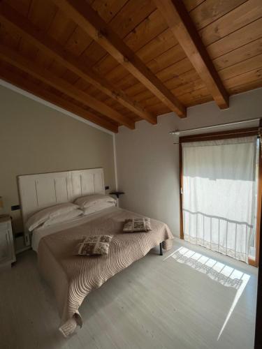 - une chambre avec un lit et une grande fenêtre dans l'établissement B&B Il Melograno, à Monzambano