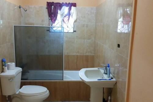 a bathroom with a toilet and a sink and a shower at PINE VALLEY ESTATES 9b BALCONY VIEW TWO BEDROOM 2 BATHROOMS 