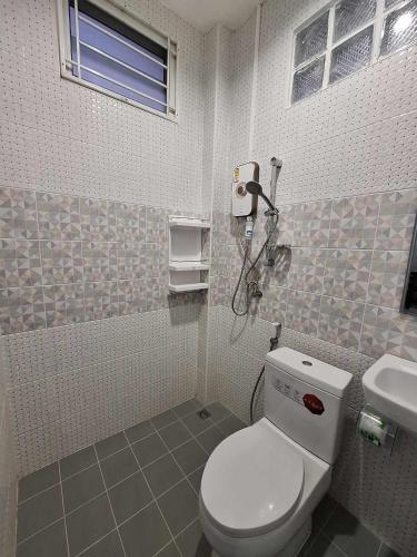 a bathroom with a toilet and a sink at PPN Garden Resort in Suwannaphum