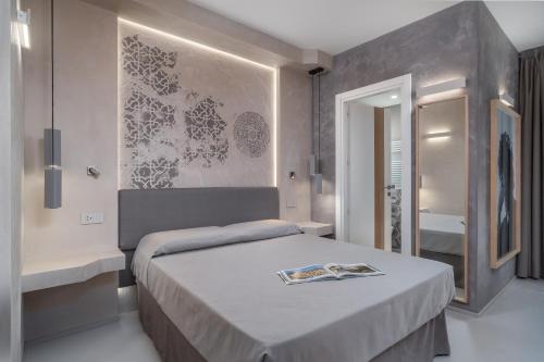 a bedroom with a large bed and a bathroom at Villa Ilma Luxury Rooms in Arzachena