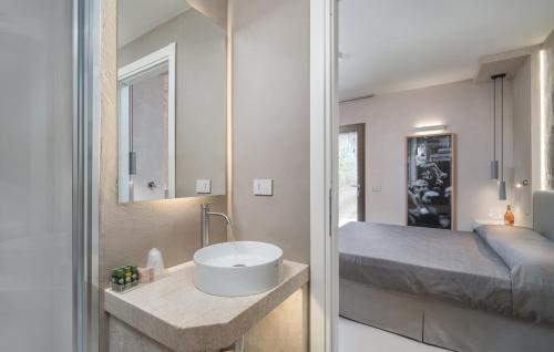 a bathroom with a sink and a bed at Villa Ilma Luxury Rooms in Arzachena