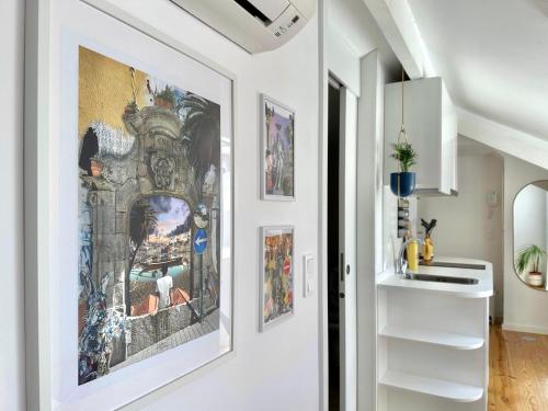 a hallway with paintings on the wall in a house at Art Cottage with oPorto View! in Vila Nova de Gaia