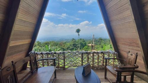a room with a view of the mountains from a window at Villa Lumbung Salak in Bogor