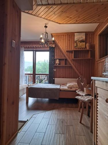 a bedroom with a bed and a balcony at Willa Marianna in Zakopane