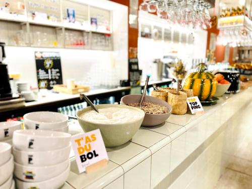 a counter in a store with bowls of food on it at The People - Strasbourg in Strasbourg