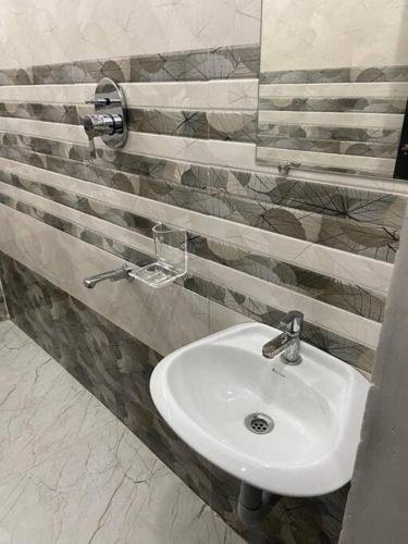 a bathroom with a white sink in a room at Variyar Service Apartments Unit B 1st Floor in Vellore