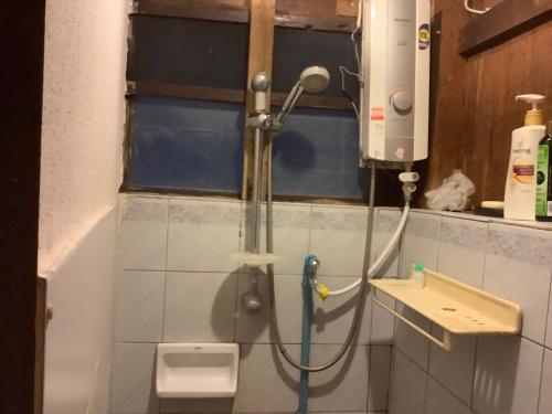 a shower in a bathroom with a toilet at Tata GuestHouse in Chiang Mai