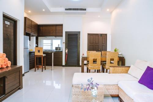 a living room with a couch and a dining room at Layantara Villas in Layan Beach