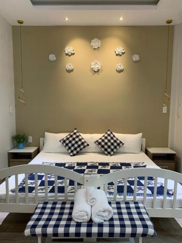a bedroom with a bed with plates on the wall at Kata Home in Danang
