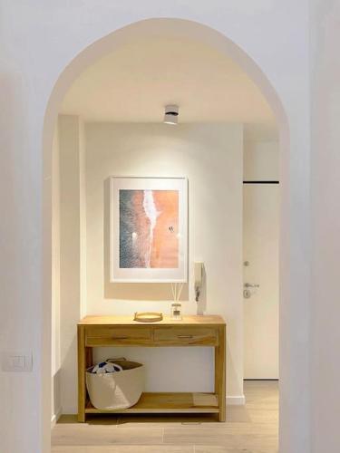 a hallway with a table and a picture on the wall at Beach & Style in Francavilla al Mare