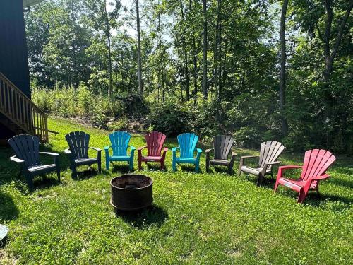 a group of colorful chairs sitting in the grass at Headlands Airbnb in Rockport