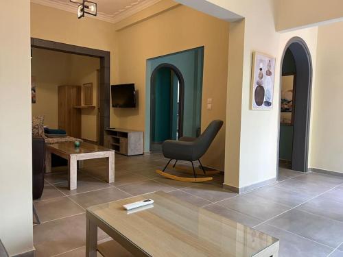 a living room with a chair and a table at Spacious and beautiful house in Piraeus