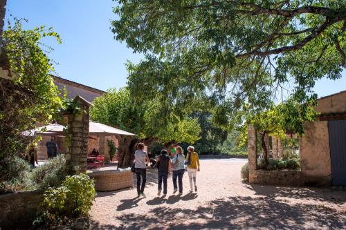 a group of people walking through a courtyard at Commanderie de Peyrassol- Bastide de La Rouvière in Flassans-sur-Issole