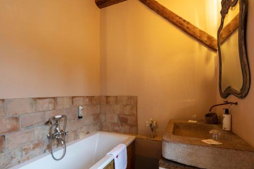 a bathroom with a tub and a sink at Commanderie de Peyrassol- Bastide de La Rouvière in Flassans-sur-Issole