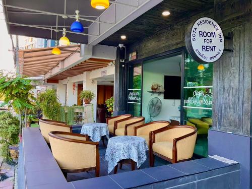 a restaurant with tables and chairs on a patio at Sota Residence in Pattaya South