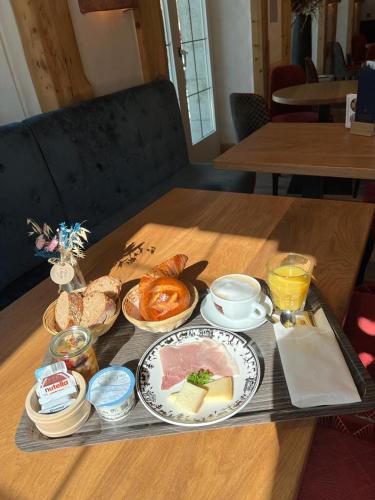 a tray of food on a table with food at Résidence le Sapin & Bains de la Gruyère in Charmey