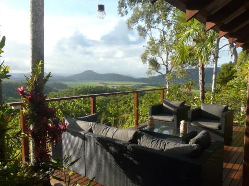 a patio with a couch and chairs on a balcony at Mai Tai Resort in Cassowary