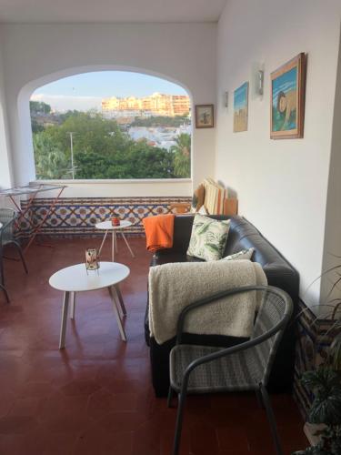 a living room with a couch and a table at Maria Guest house in Albufeira
