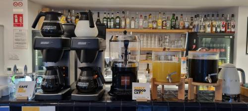 a counter top with a coffee maker and a drink at The People - Marseille in Marseille