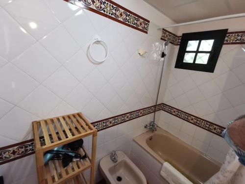 a bathroom with a tub and a toilet and a sink at 2 Piscinas en Isla Canela in Huelva