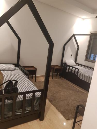 a bedroom with two beds and a mirror at Casa Fainna in Casablanca