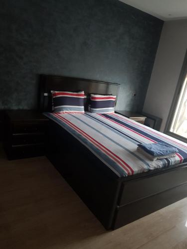 a bed with two pillows on it in a bedroom at Casa Fainna in Casablanca