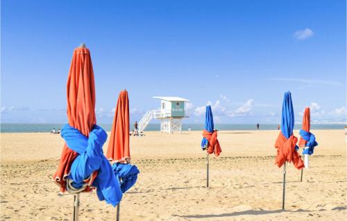 a group of closed umbrellas on a beach at Nice Home In La Croupte With Wifi in La Croupte