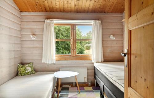 a room with two beds and a window at Amazing Home In Stege With Kitchen in Stege
