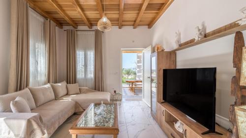 a living room with a couch and a flat screen tv at Milion Fantasy House in Adamas