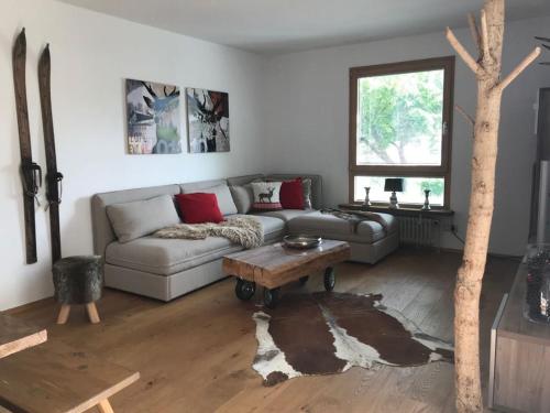 ein Wohnzimmer mit einem Sofa und einem Tisch in der Unterkunft Schliersee-Lounge in Schliersee