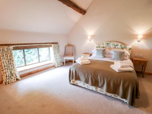 a bedroom with a large bed and a window at Tithe Barn in Derby