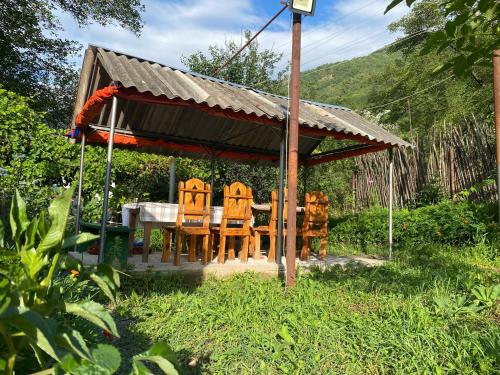 a gazebo with a table and chairs at Tereza glamping in Sanain