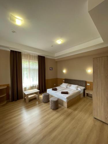 a large bedroom with a large bed in a room at Praktik Hotel & Restaurant in Berehove