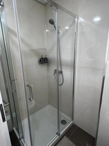 a shower with a glass door in a bathroom at Casa da Praça in São João da Madeira