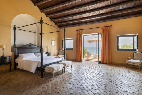 A bed or beds in a room at Falconara Greenblu Resort