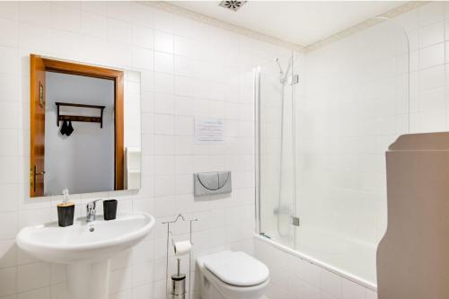 a bathroom with a sink and a toilet and a shower at A ver o mar rooms- Funchal city center in Funchal